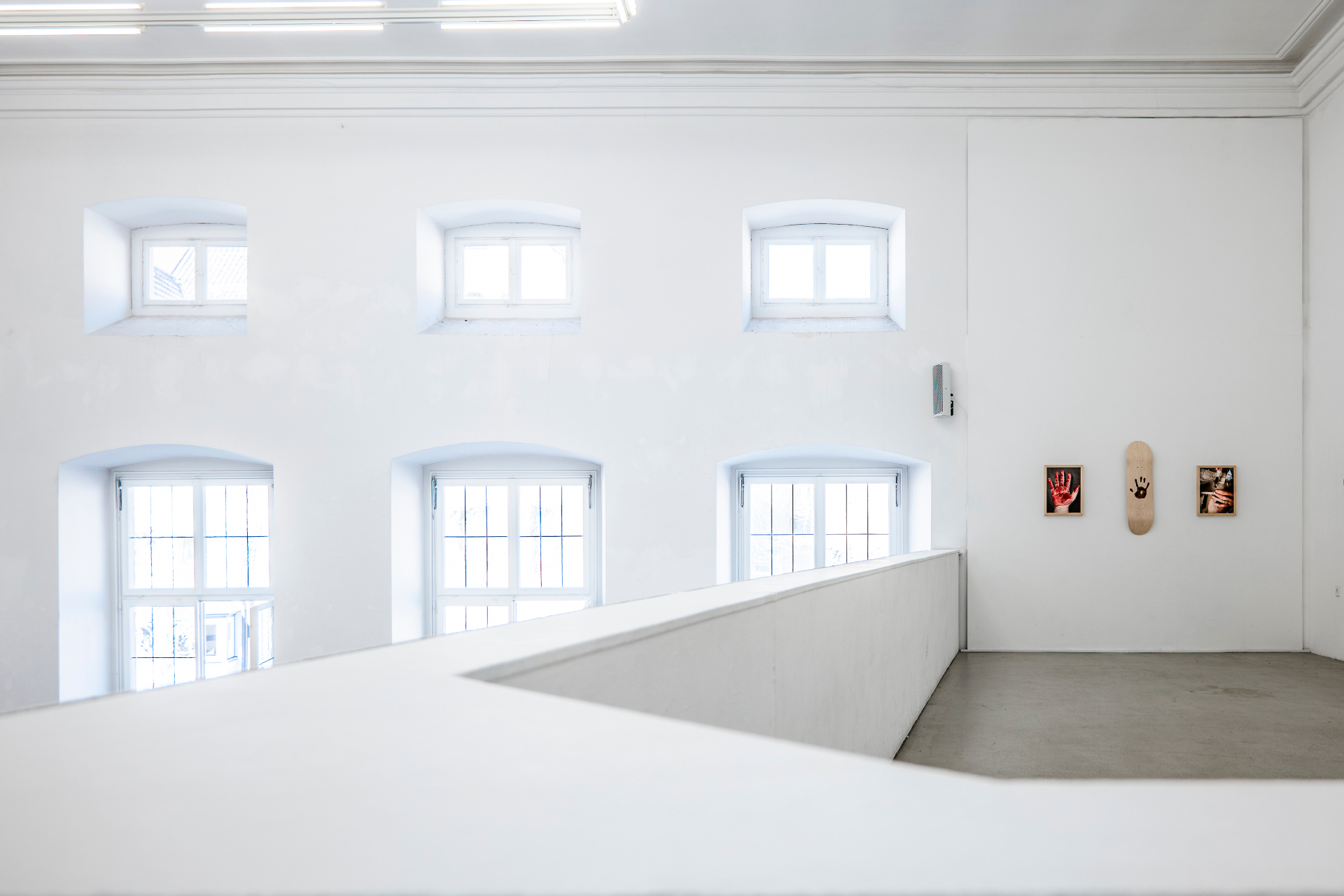 Installation view — hanging light sculpture over the deck wall